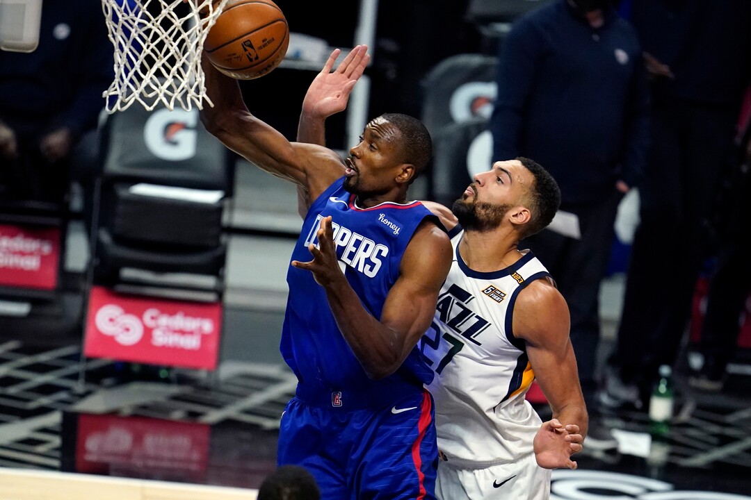Los Angeles Clippers forward Serge Ibaka, left, grabs a rebound next to Utah Jazz center Rudy Gobert during the first half of an NBA basketball game Wednesday, Feb. 17, 2021, in Los Angeles. (AP Photo/Marcio Jose Sanchez)