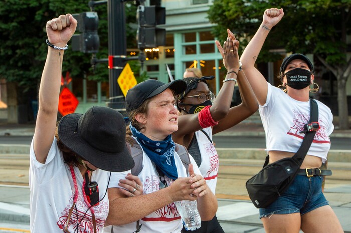 (Rick Egan  |  The Salt Lake Tribune)   Protesters wear “Drop The Charges” t-shirts, as they dance in the streets of Salt Lake City, during the Dance Dance Revolution protest for racial equality, on Sunday, Aug. 9, 2020.