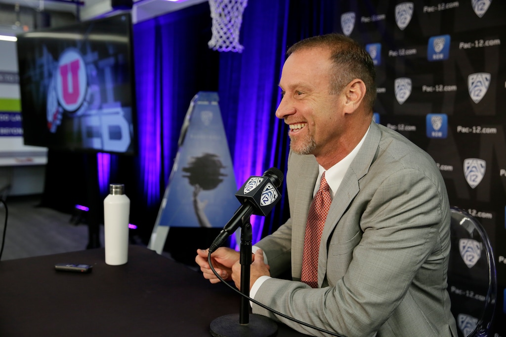 FILE - In this Oct. 11, 2018, file photo, Utah head coach Larry Krystkowiak answers questions during the Pac-12 NCAA college basketball media day, in San Francisco. Rebuilding is not in Utah's basketball vocabulary. Only one full-time starter returns for the Utes from last year's team that finished as the NIT runner-up. Three of the top four scorers graduated. It's a primary reason why Utah was picked to finish eighth in the Pac-12 preseason media poll. Still, the Utes have created a habit of defying expectations under head coach Larry Krystkowiak.(AP Photo/Eric Risberg, File)