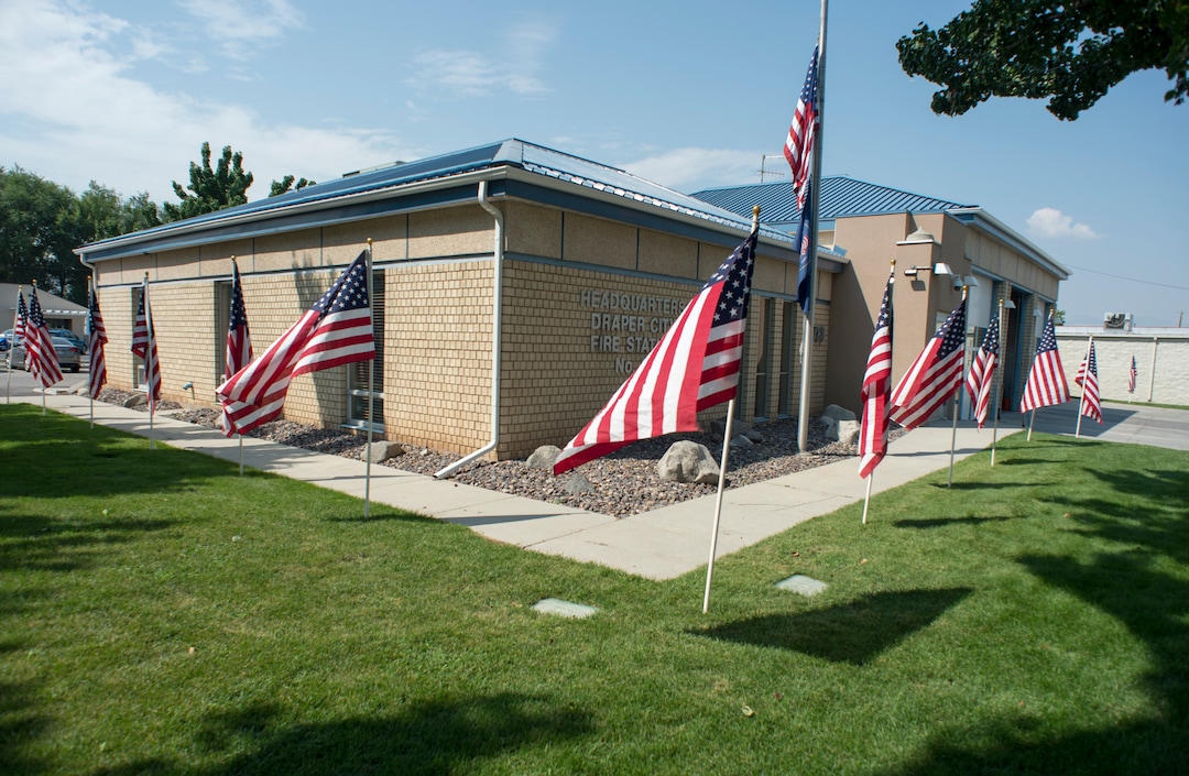 (Rick Egan  |  The Salt Lake Tribune)      American flags fly at the Draper Fire Station in memory of Draper firefighter Matt Burchett, 42, who died fighting wildfires in California. Tuesday, Aug. 14, 2018.