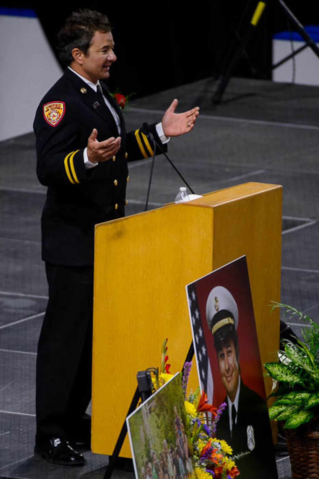 (Trent Nelson | The Salt Lake Tribune)  Dominic Burchett (brother) encourages the audience to get up and make some noise at the funeral services for Battalion Chief Matthew Burchett at the Maverik Center in West Valley City, Monday Aug. 20, 2018.