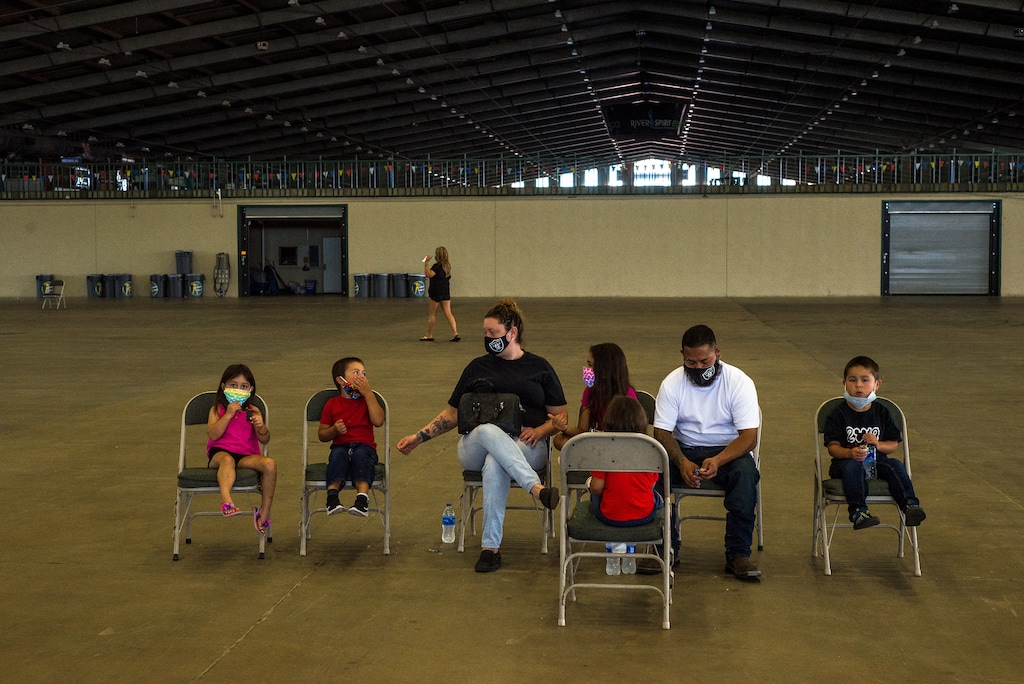 (Joseph Rushmore | The New York Times)
A couple waiting with their children wait to be helped with filing unemployment insurance claims during an in-person event run by the Oklahoma Employment Security Commission, in Tulsa, Okla., July 24, 2020. "Republicans have a long history of suggesting that the jobless are moral failures — that they’d rather sit home watching TV than work. And the Trump years have been marked by a relentless assault on programs that help the less fortunate, from Obamacare to food stamps," said Paul Krugman.