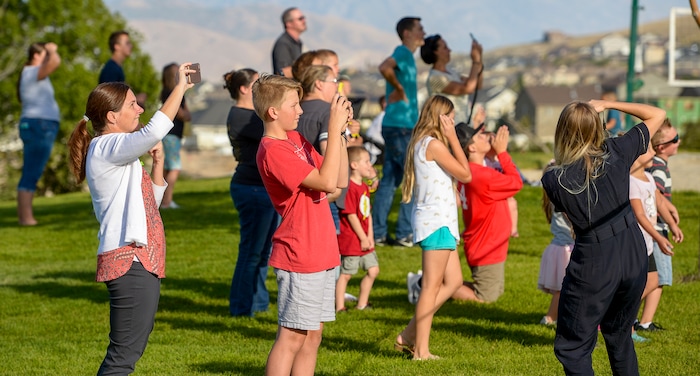 Leah Hogsten  |  The Salt Lake Tribune   Homeowners who were not allowed to return to their homes and onlookers waited near Herriman Cove pond to watch as a firefighting helicopter refilled. A 50-acre wildfire in Rose Canyon was threatened about a half-dozen homes Wednesday, Sept. 12, 2018. A spokesman for Unified Fire said the blaze has already burned a few structures, including outhouses and sheds. Firefighters have evacuated around 20 to 30 homes in two neighborhoods near 15555 S. Rose Canyon Road in Herriman. 