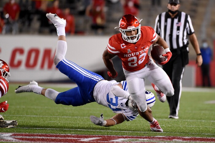 Houston running back Kyle Porter (22) escapes a tackle by Houston defensive lineman Derek Parish during the first half of an NCAA college football game, Friday, Oct. 16, 2020, in Houston. (AP Photo/Eric Christian Smith)