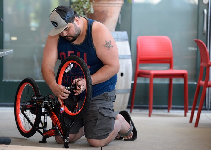 (Francisco Kjolseth  |  The Salt Lake Tribune)  Benjamin Holescott joins other volunteers and workers at Squatter's Pub Brewery to assemble 80 bicycles for kids on Tuesday, May 29, 2018. The bikes will be given away to 1st and 2nd graders at Washington Elementary on Wednesday as part of a program backed by the Can'd Aid Foundation.