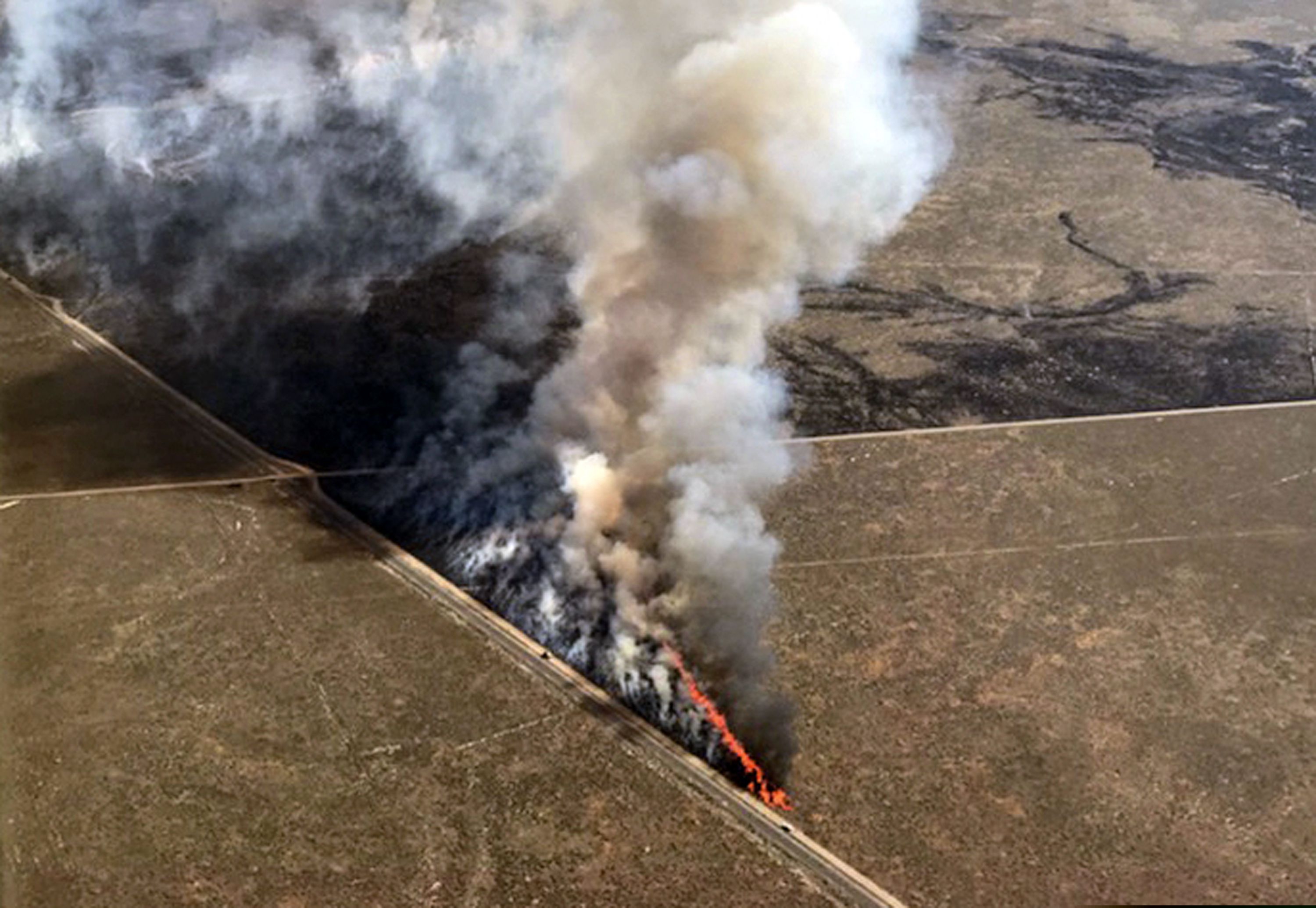 (Bureau of Land Management via AP) This photo provided by the U.S. Bureau of Land Management shows wildfires burning in Idaho, Wednesday, July 24, 2019. The largest wildfire at the nation's primary nuclear research facility in recent history had been burning close to buildings containing nuclear fuel and other radioactive material, but a change in wind direction Wednesday was pushing the flames into open range at the sprawling site in Idaho, officials said. The lightning-caused fire at the Idaho National Laboratory is one of several across the U.S. West.