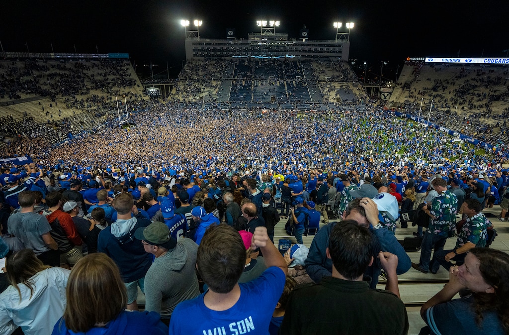 (Rick Egan | The Salt Lake Tribune) BYU fans storm the field as the Brigham Young Cougars defeat the Utah Utes 26-17, at Lavell Edwards Stadium in Provo, on Saturday, Sept. 11, 2021.