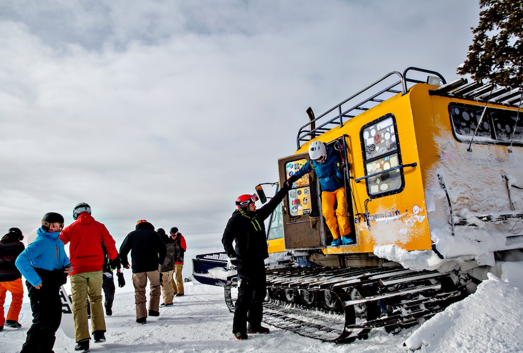 (Kim Raff | The New York Times) People exit the Lightning Ridge snowcat for access to that section of the Powder Mountain resort in Utah, Jan. 31, 2020. Head north from Salt Lake City to visit Snowbasin and Powder Mountain, relatively undiscovered gems of the state's ski scene.
