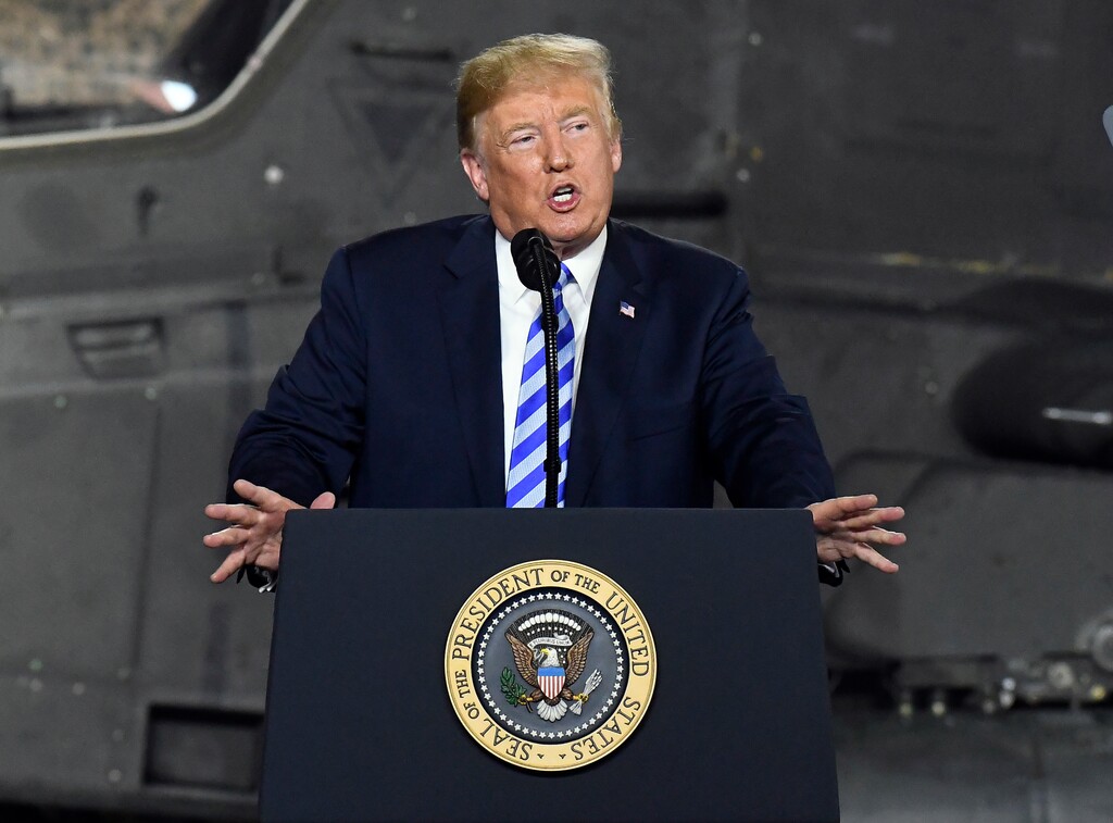 FILE - In this Aug. 13, 2018 file photo, President Donald Trump speaks before signing a $716 billion defense policy bill named for Sen. John McCain  in Fort Drum, N.Y.  Trump says he’s asking federal regulators to look into the effectiveness of the quarterly financial reports that publicly traded companies are required to file.  In a tweet early Friday, Aug. 17, Trump said that after speaking with “some of the world’s top business leaders,” he’s asked the U.S. Securities and Exchange Commission to determine whether shifting to a six-month reporting regimen would make more sense.  (AP Photo/Hans Pennink, File)