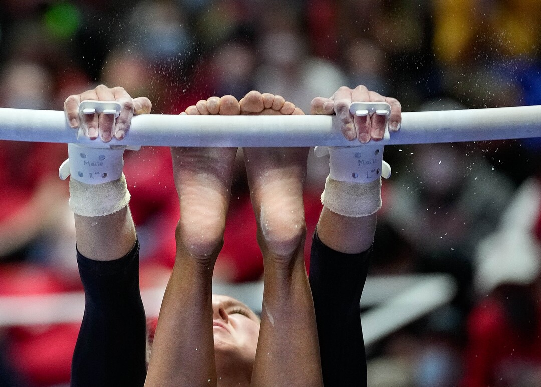 (Francisco Kjolseth | The Salt Lake Tribune) Utah’s Maile O’Keefe spins on the bars during their gymnastics meet with Stanford at the Huntsman Center in Salt Lake City, Saturday, Jan. 29, 2022.
