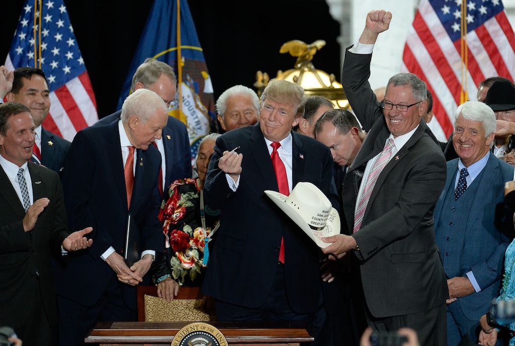 (Francisco Kjolseth | Tribune file photo) Bruce Adams, right, chairman of the San Juan County Commission, has his hat signed by President Donald Trump at the Utah Capitol on Monday, Dec. 4, 2017, after Trump's signing of two presidential proclamations to shrink Bears Ears and Grand Staircase-Escalante national monuments. The county has spent hundreds of thousands of dollars in attorneys fees trying to achieve such a result.