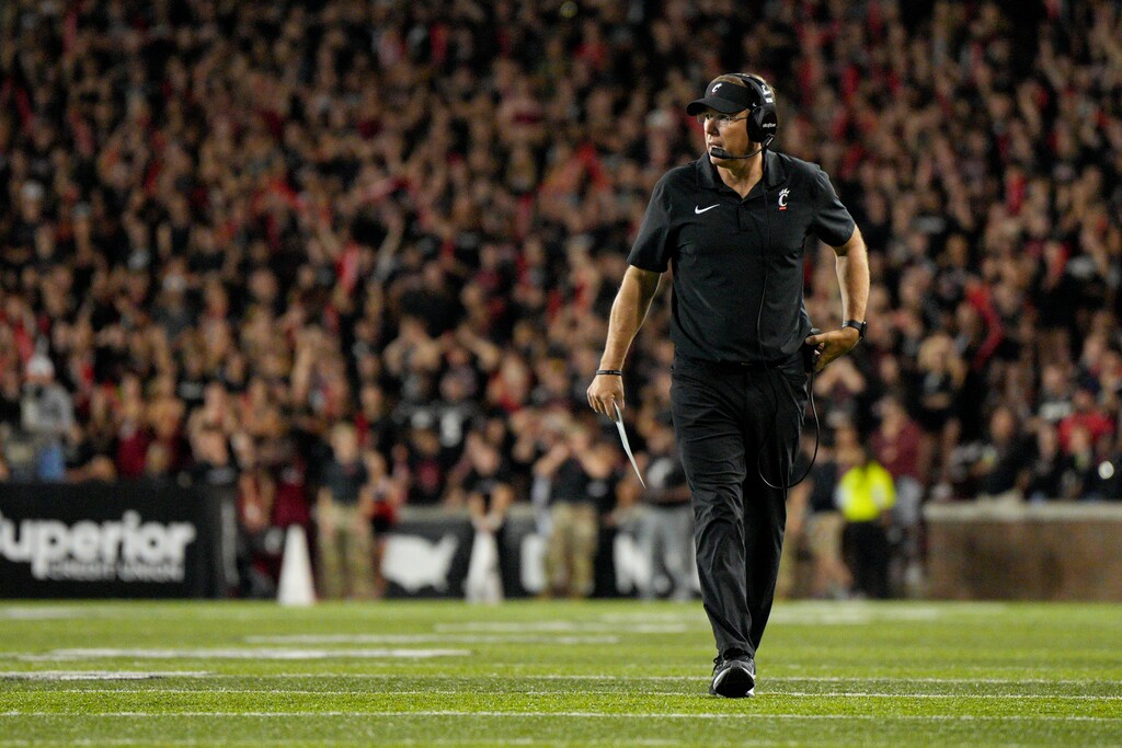 (Jeff Dean | AP) Cincinnati head coach Scott Satterfield walks on the field during a stoppage in play in the second half against Miami (Ohio), Saturday, Sept. 16, 2023.