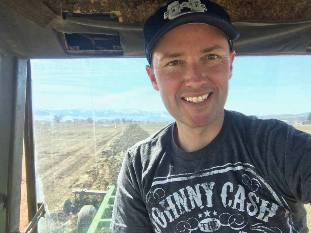 (photo courtesy Spencer Cox)  Lt. Governor Spencer Cox drives a tractor on his farm near Fairview.
