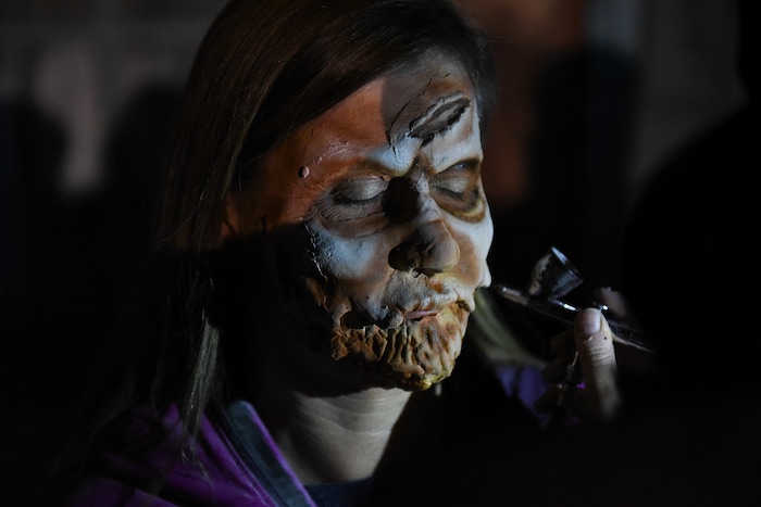 (Francisco Kjolseth  |  The Salt Lake Tribune)  Salt Lake County Councilmember Jenny Wilson is transformed by makeup artist Chelsea Harbert as local politicians fall prey to the zombie apocalypse at the Fear Factory on Thursday, Oct. 12, 2017, for a special event to raise awareness of the Utah Food Bank and kick start donations. 