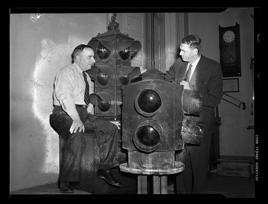 (The Salt Lake Tribune) Lester Wire, at right, N.W. Silver and a pair of later metal traffic lights in 1940.