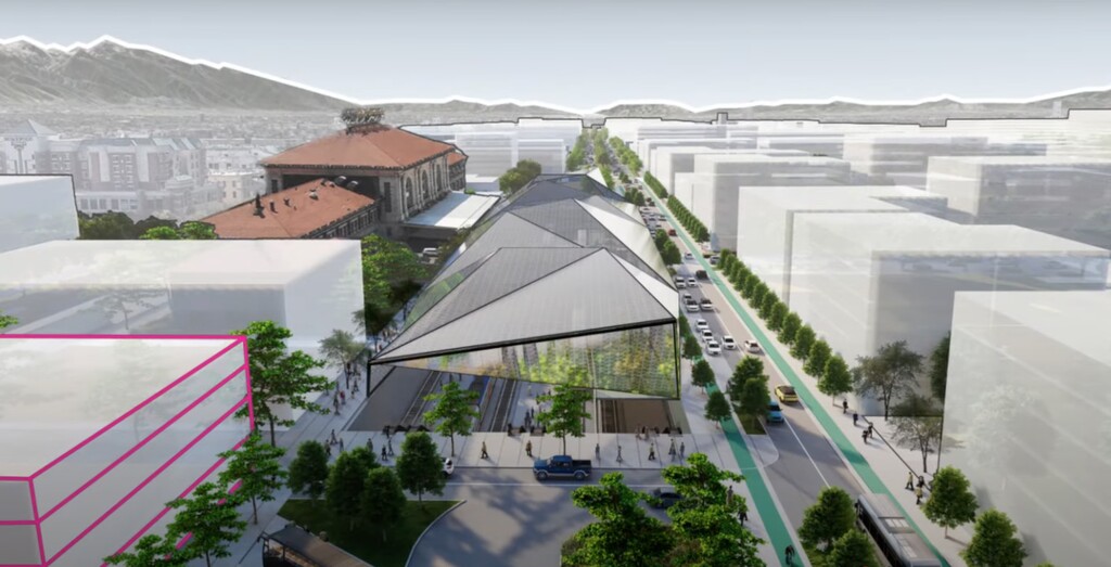 The historic Rio Grande Depot stands at left while a glass canopy protects new rail platforms in front of the building.