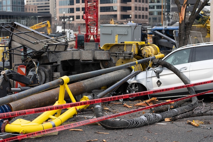 (Francisco Kjolseth | The Salt Lake Tribune) A collapsed drill rig is seen on Wednesday, March 16, 2022, at the intersection of State Street and 200 South. The rig toppled over Tuesday night at the site of the new Astra Tower, crushing two unoccupied parked cars and sending the crane operator to the hospital in serious condition.
