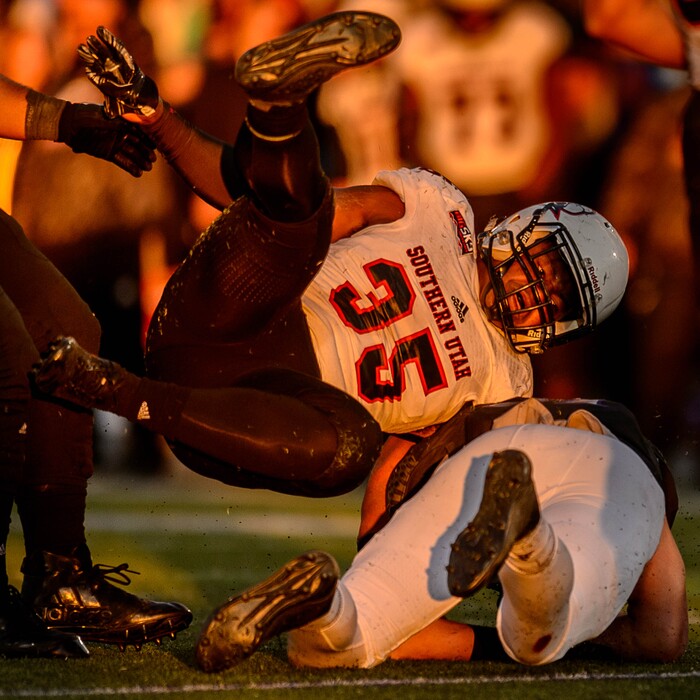 (Trent Nelson | The Salt Lake Tribune)  Southern Utah Thunderbirds linebacker Chinedu Ahanonu (35) dives on Weber State Wildcats tight end Andrew Vollert (87) as Weber State hosts Southern Utah, NCAA football in Ogden Saturday October 14, 2017.
