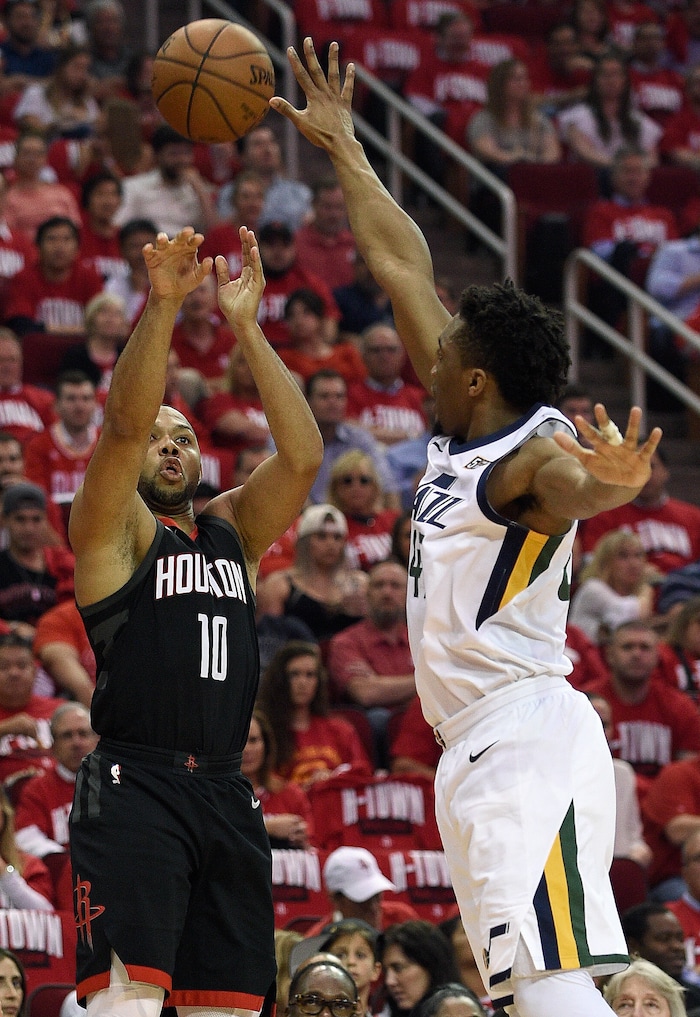 Houston Rockets guard Eric Gordon (10) shoots as Utah Jazz guard Donovan Mitchell defends during the first half in Game 2 of an NBA basketball second-round playoff series Wednesday, May 2, 2018, in Houston. (AP Photo/Eric Christian Smith)