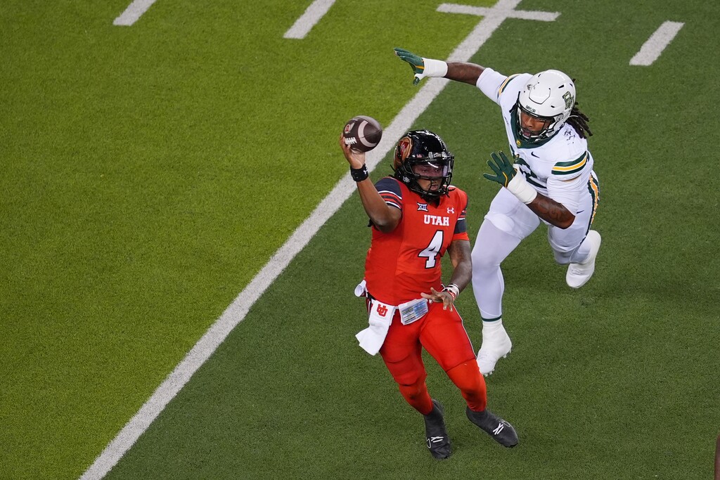 (Julio Cortez | AP) Utah quarterback Devon Dampier (4) attempts a pass as Baylor linebacker Emar'Rion Winston applies pressure during the first half of an NCAA college football game Saturday, Nov. 15, 2025, in Waco, Texas.