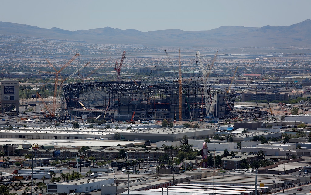 Construction cranes surround the future NFL Raiders football stadium Tuesday, June 4, 2019, in Las Vegas. The Las Vegas Bowl is moving to the new stadium next year, and will feature teams from the SEC or Big Ten conferences against a Pac-12 contender. (AP Photo/John Locher)