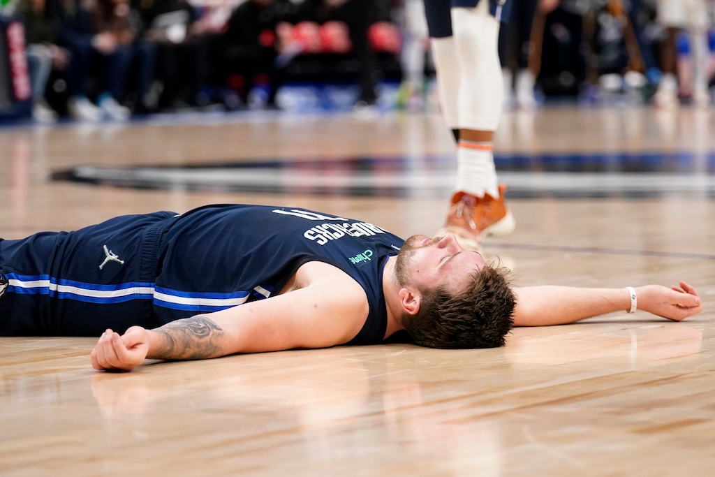 Dallas Mavericks guard Luka Doncic lies on the court after being fouled on a shot-attempt in the second half of an NBA basketball game against the Utah Jazz in Dallas, Monday, March, 7, 2022. (AP Photo/Tony Gutierrez)