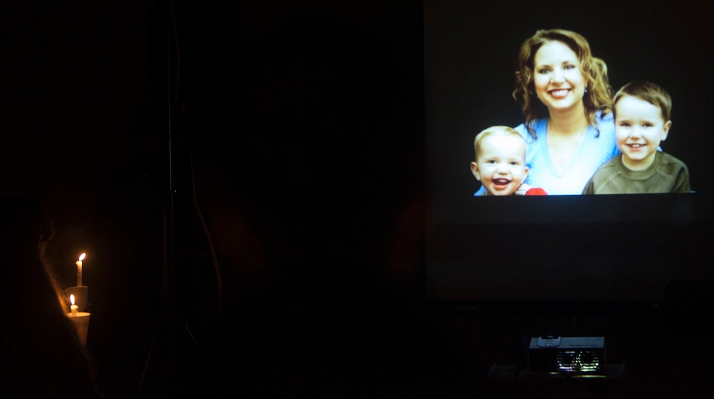 (Tribune file photo) A photographic slide show of Susan Powell and her sons, Charlie and Braden, is projected on a covered picnic area during a vigil at West View Park in West Valley City, Utah Tuesday February 5, 2013. The vigil was to commemorate the one year anniversary of the boys' death.