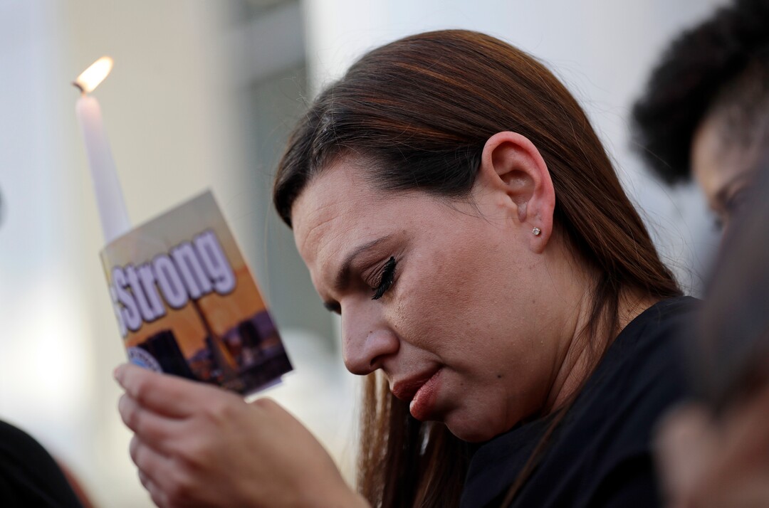 (Gregory Bull  |  AP Photo)  Kristin Alexander holds a candle during a vigil at City Hall in Las Vegas, Monday, Oct. 2, 2017. The vigil was held in honor of the over 50 people killed and hundreds injured in a mass shooting at an outdoor music concert late Sunday.