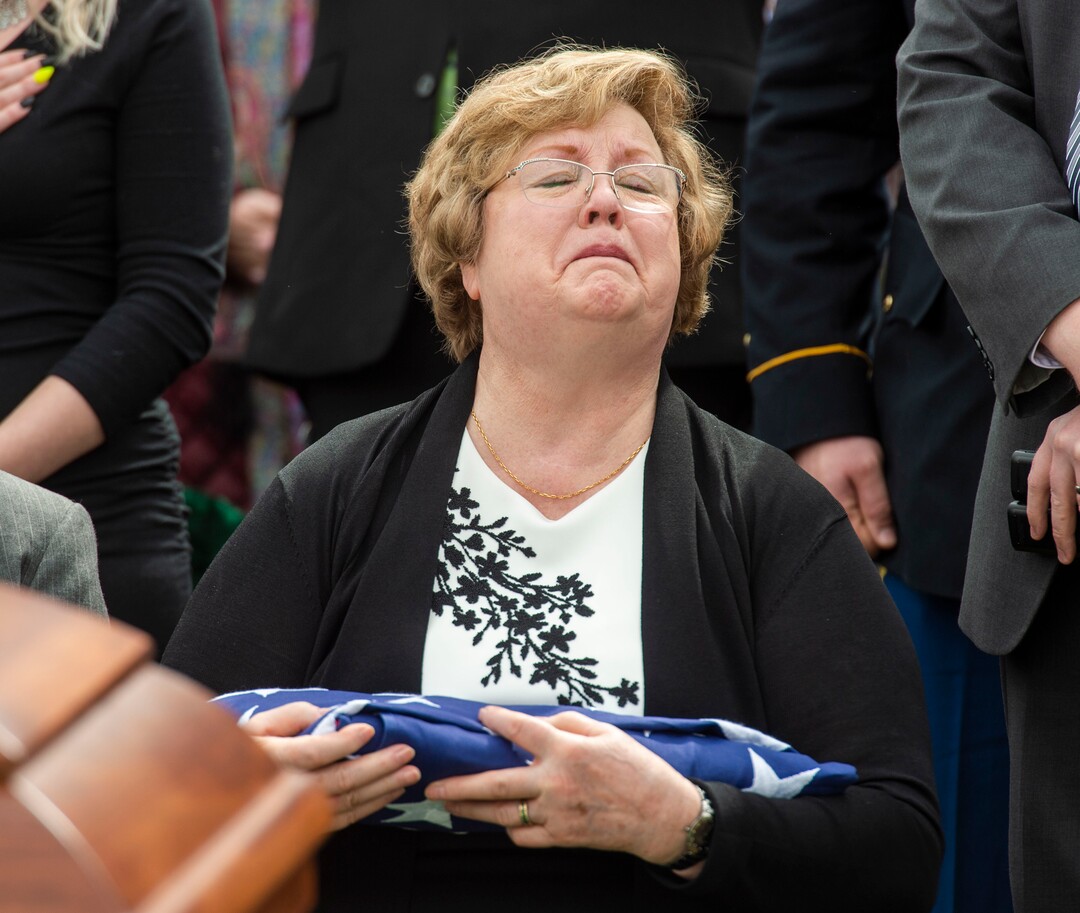 (Rick Egan  |  The Salt Lake Tribune)     Mary Ann Turner, the daughter of 2nd Lt. Lynn W. Hadfield, holds the flag the was just preselected to her, from his casket during the graveside service for her father, who was killed during the Second World War, at Veterans Memorial Park, in Bluffdale. Thursday, March 21, 2019.
