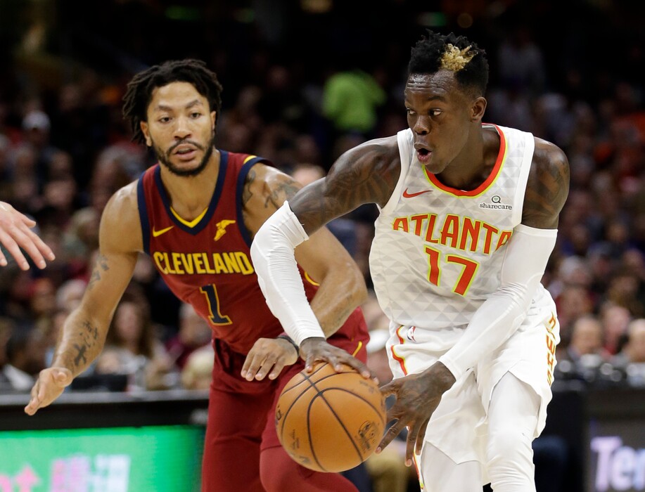 Atlanta Hawks' Dennis Schroder (17), from Germany, looks to pass against Cleveland Cavaliers' Derrick Rose (1) in the first half of an NBA basketball game, Sunday, Nov. 5, 2017, in Cleveland. (AP Photo/Tony Dejak)