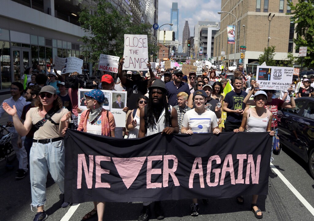FILE - In this July 4, 2019, file photo, protesters assembled by a majority Jewish group called Never Again Is Now walk through traffic as they make their way to Independence Mall in Philadelphia. A fledgling coalition of liberal Jewish groups is increasingly making itself heard as it fights the Trump administration’s immigration policies. (AP Photo/Jacqueline Larma, File)