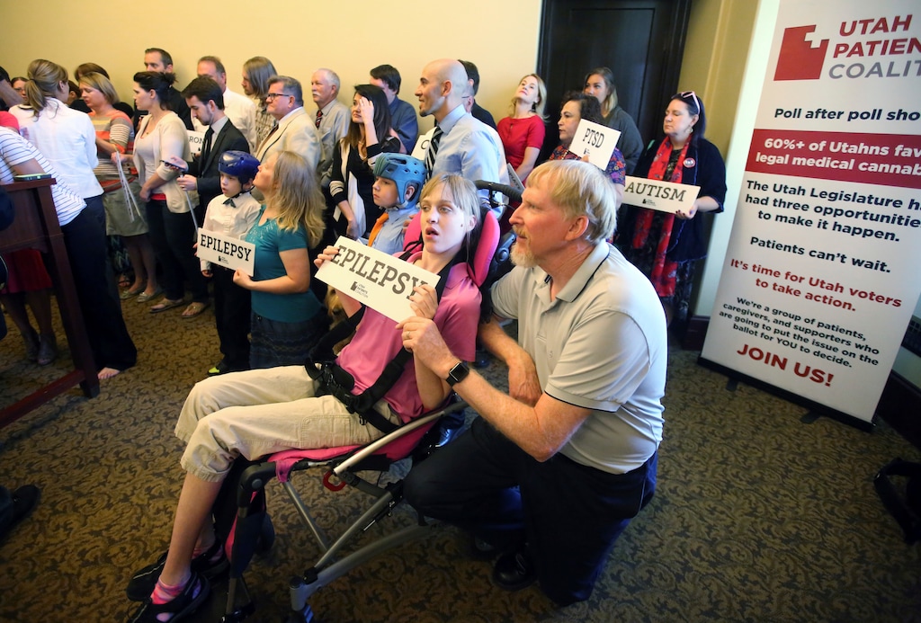 (Rick Bowmer  |  AP Photo) In this June 26, 2017, file photo, Doug Rice, right, and his daughter Ashley, left, look on with other patients, caregivers and supporters during the Utah Patients Coalition news conference at the Utah State Capitol, in Salt Lake City. Medical marijuana backers are moving forward with a ballot initiative to ask Utah voters directly to pass a broad medical marijuana law next year. The Utah Patients Coalition got state approval Thursday, Aug. 10, 2017, to start collecting the 113,143 voter signatures for the ballot initiative in November 2018.


Doug Rice, right, and his daughter Ashley, left, look on with other patients, caregivers and supporters during the Utah Patients Coalition news conference at the Utah State Capitol Monday, June 26, 2017, in Salt Lake City. A group of activists and Utah residents with chronic conditions has launched a ballot initiative to ask voters next year to pass a broad medical marijuana law.