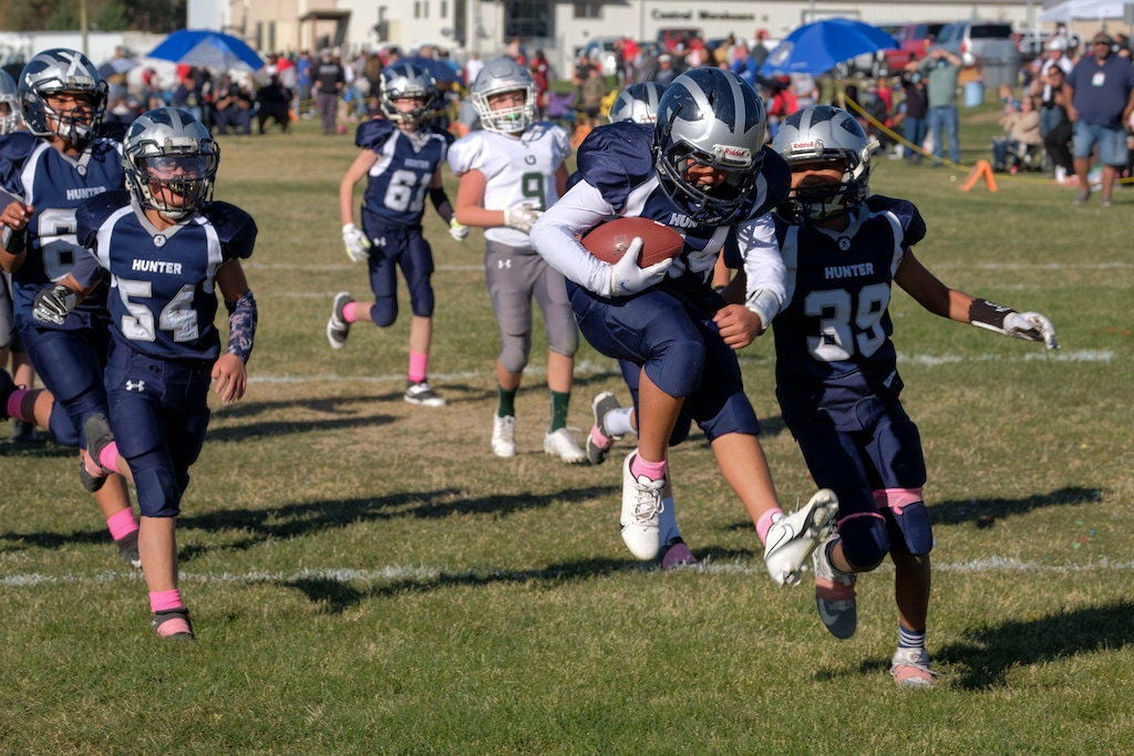 (Leah Hogsten | The Salt Lake Tribune) The Hunter Pee-Wee team scores a touchdown in a 26-20 win over Olympus Gray during a Ute Conference youth football championship at Mount Jordan Middle School on Oct. 31, 2020. The Ute Conference, the largest youth football league in the state, ran an 11-week season for 6,000 kids over the summer yet saw just 30 confirmed cases of COVID-19.