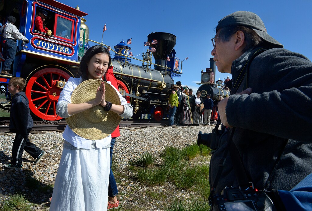 Scott Sommerdorf | The Salt Lake Tribune
New York photographer Corky Lee, right, works with dancer Wan Zhao near one of the two locomotives used in the re-enactment of the Golden Spike ceremony, Saturday, May 10, 2014. The Chinese community honored Chinese immigrants who built the railroad from the west by taking more than three busloads of people to the Golden Spike National Monument for the 145th commemoration of the completion of the transcontinental railroad.