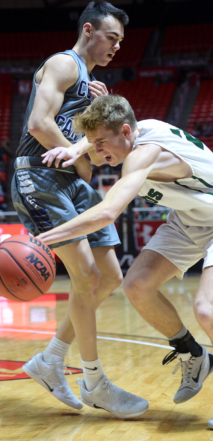 (Leah Hogsten | The Salt Lake Tribune) Olympus' Jacob DowDell (02) fights to round Corner Canyon's John Mitchell (02). Olympus plays Corner Canyon for the 5A High School BoysÕ Basketball Tournament Championship at the Jon M. Huntsman Center in Salt Lake City, Saturday, March 3, 2018.