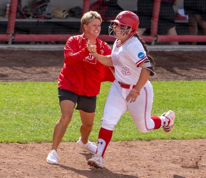 (Rick Egan | The Salt Lake Tribune)  Utah Head coach Amy Hogue celebrates with Julia Jimenez after she hit a grand slam home run, giving Utah a 7-1 lead, in NCAA Softball Super Regionals action between the Utah Utes and the San Diego State Aztecs, on Saturday, May 27, 2023.
