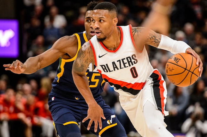(Trent Nelson | The Salt Lake Tribune)  Portland Trail Blazers guard Damian Lillard (0) drives around Utah Jazz guard Donovan Mitchell (45) as the Utah Jazz host the Portland Trail Blazers, NBA basketball in Salt Lake City, Wednesday November 1, 2017.