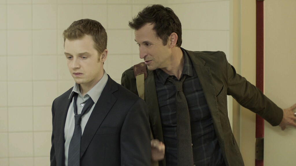 (Photo courtesy CBS) Daniel (Noah Wyle, right) confronts the police officer (Noel Fisher) who shot and killed his husband in "The Red Line."