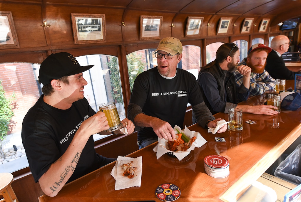 (Francisco Kjolseth  |  The Salt Lake Tribune) Trolley Wing Co. co-owners Jeff Krie, left, and Jesse Wilkerson are photographed in 2019 in the bar's namesake trolley car location, which they had to close this week so they could transfer its liquor license to another location.