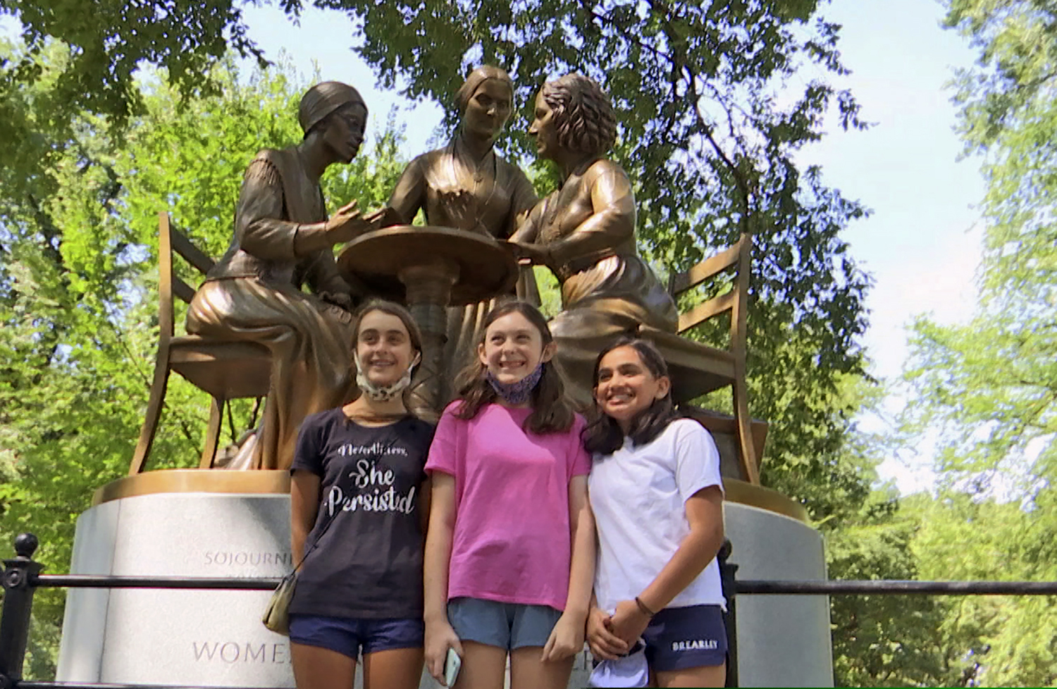 Young visitors attend an unveiling of a statue honoring suffragettes in Central Park on Aug. 26, 2020.  The bronze statue depicts women’s rights pioneers Sojourner Truth, Elizabeth Cady Stanton and Susan B. Anthony.(AP Photo/Ted Shaffrey)