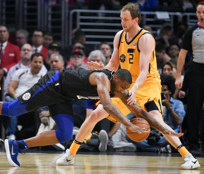 Los Angeles Clippers guard Sindarius Thornwell, front, loses the ball as he falls to the court while Utah Jazz forward Joe Ingles defends during the first half of an NBA basketball game in Los Angeles, Thursday, Nov. 30, 2017. (AP Photo/Kelvin Kuo)