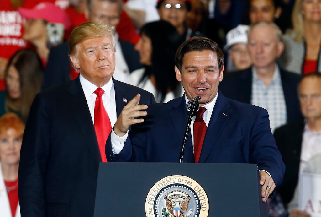 (Butch Dill | AP) Then-President Donald Trump stands behind Ron DeSantis at a 2018 gubernatorial rally in Pensacola, Fla.