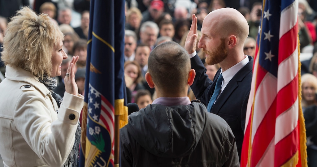 Steve Griffin  |  The Salt Lake Tribune

 Salt Lake City Council member Derek Kitchen takes the oath of office administered by city recorder Cindi Mansell during a ceremony at the City & County Building in Salt Lake City, Monday, Jan. 4, 2016. Kitchen is joined by his husband, Moudi Sbeity, for the event.