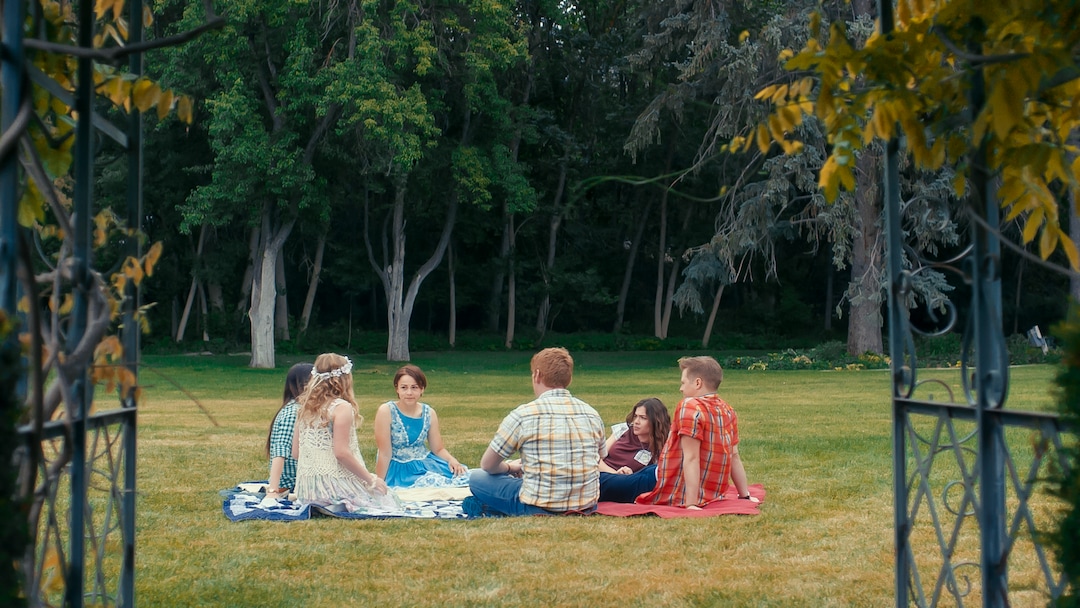 (Photo courtesy Pinnacle Peak Pictures) The March sisters — from left, Meg (Melanie Stone), Amy (Elise Jones), Beth (Allie Jennings) and Jo (Sarah Davenport) — enjoy a picnic with their friend Laurie (Lucas Grabeel, right) and his tutor Brooke (Stuart Edge), in a scene from director Clare Niederpruem's modern-day adaptation of Louisa May Alcott's "Little Women."