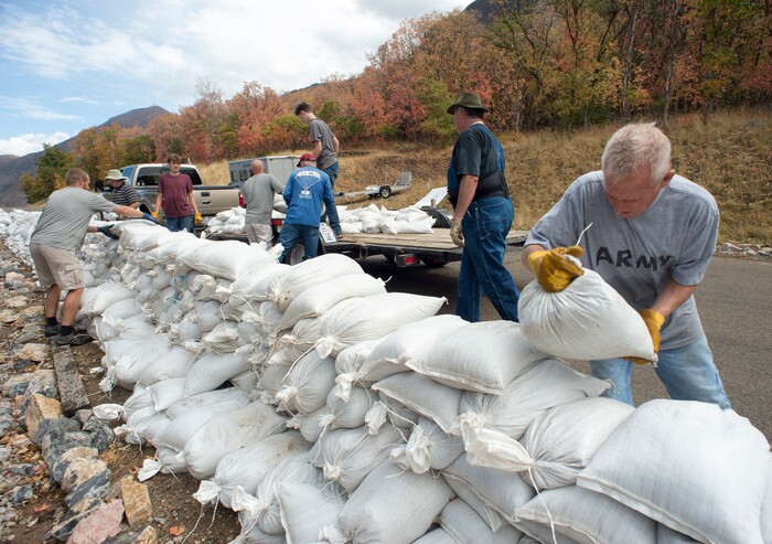 (Rick Egan  |  The Salt Lake Tribune)     Residents of Woodland Hills, make a sand bag barricad, after being warned of possible flash floods with the coming rain, due to the recent fires in the area.  Monday, Oct. 1, 2018.


