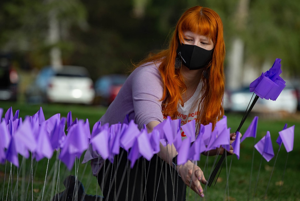 (Francisco Kjolseth | The Salt Lake Tribune) Christa Lynn Luckenbach helps plant flags at Liberty Park in Salt Lake City, on Saturday, Oct. 17, 2020, to recognize the thousands of individuals in Utah who are impacted by domestic violence each year for the Stop the Violence Utah campaign.