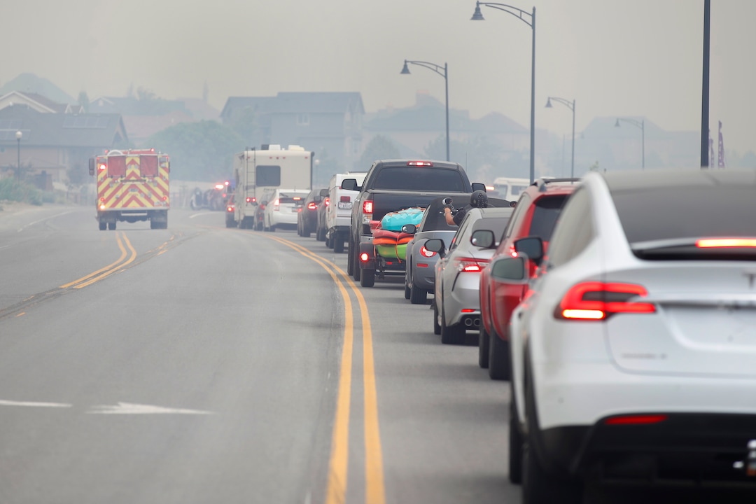 (George Frey  |  for The Salt Lake Tribune) A fire truck makes its way down the road as people wait in a long line after they were evacuated from their homes in south Saratoga Springs due to a wildfire on June 28, 2020.