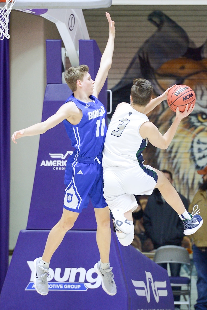 (Leah Hogsten  |  The Salt Lake Tribune) Bingham's Dalton Miller (11) tries to stop Copper Hills' Stone Hutchings (03) on his way to the net. Copper Hills faces Bingham in the 6A High School Boys' Basketball Tournament opening game at Weber State UniversityÕs Dee Events Center in Ogden, Tuesday, Feb. 27, 2018. 