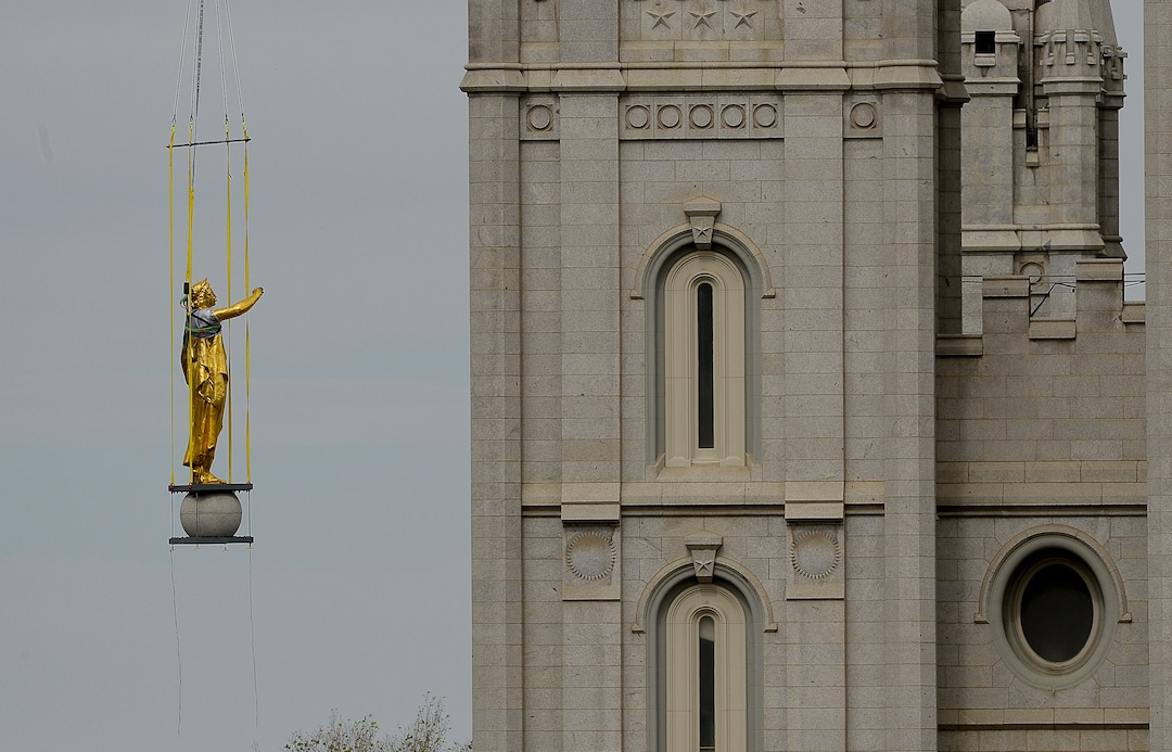 (Francisco Kjolseth  |  The Salt Lake Tribune) Crews work to remove the Angel Moroni statue atop the Salt Lake Temple of The Church of Jesus Christ of Latter-day Saints on Monday, May 18, 2020. The temple closed in December for seismic upgrades and sustained minor damager during the March 18, 2020, magnitude 5.7 earthquake when the trumpet held by the angel fell off and several smaller spire stones were displaced.