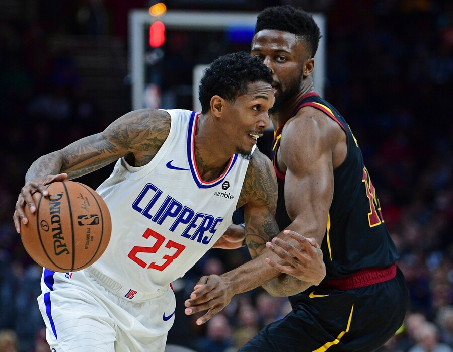 Los Angeles Clippers' Lou Williams (23) drives against Cleveland Cavaliers' David Nwaba in the first half of an NBA basketball game, Friday, March 22, 2019, in Cleveland. (AP Photo/David Dermer)